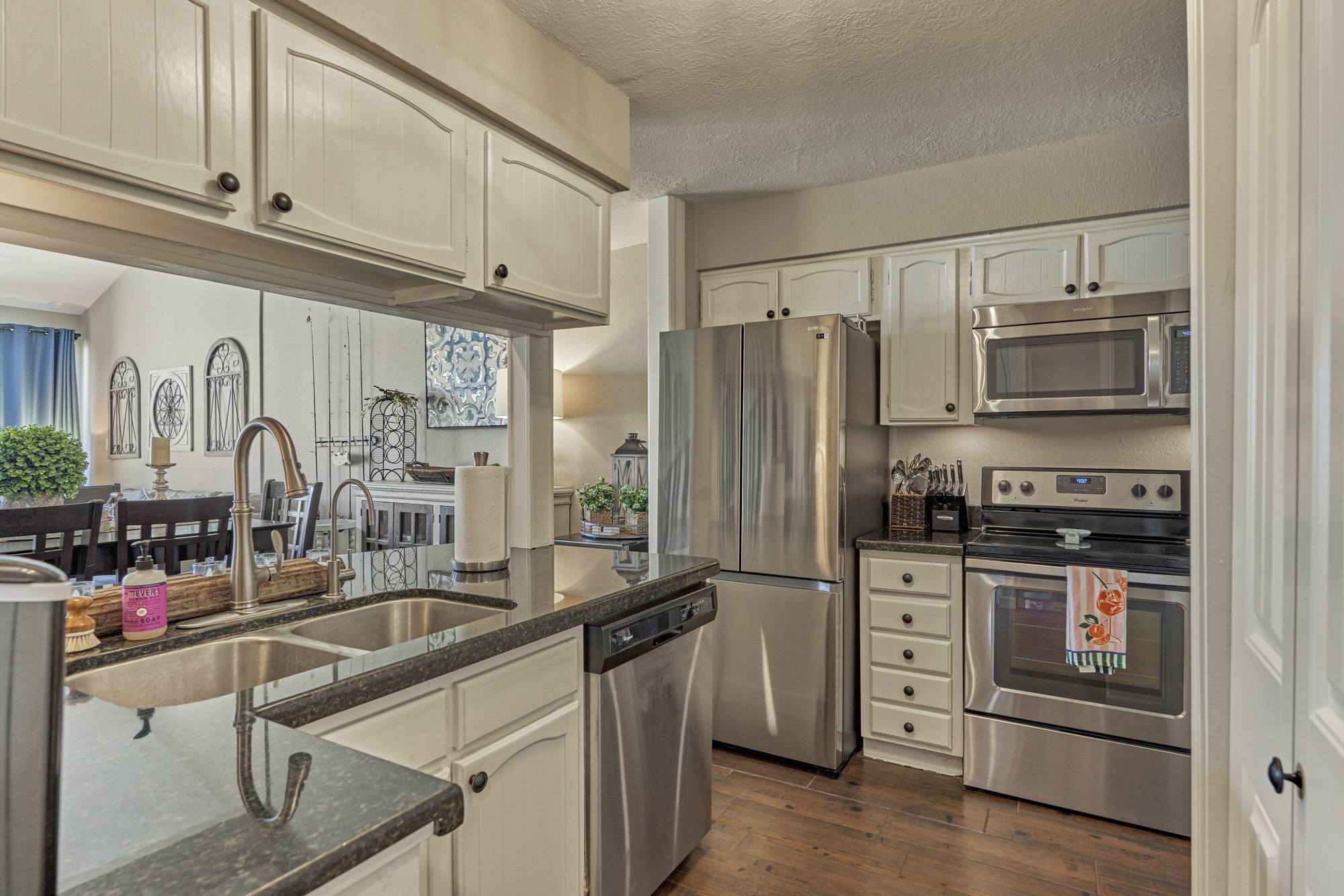 5 April Point Drive South Montgomery, TX 77356 - Photo 13 of 26 a kitchen with stainless steel appliances granite countertop a refrigerator stove and sink