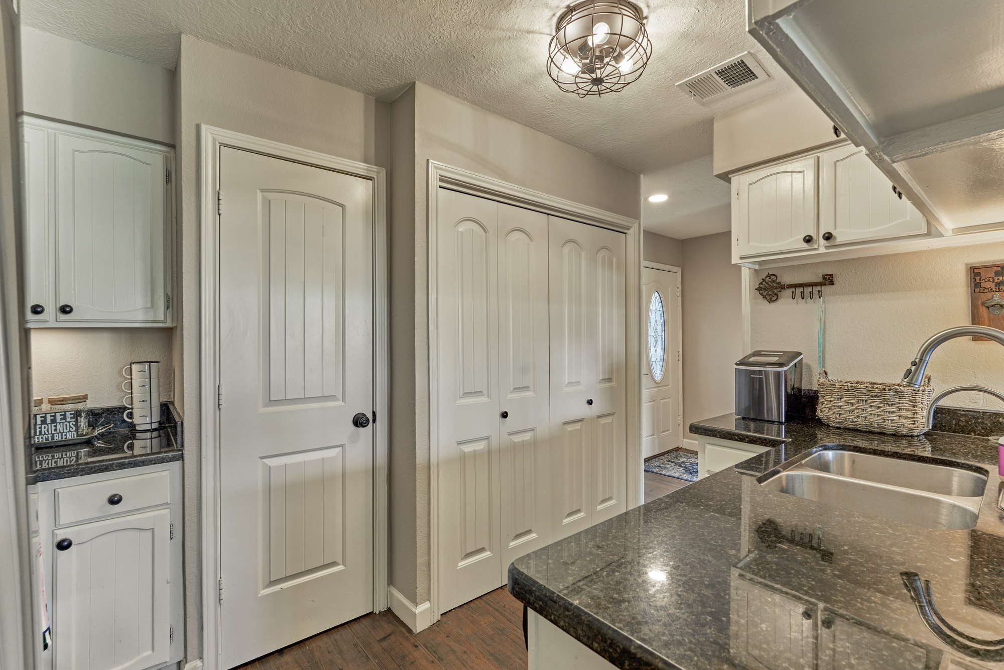 5 April Point Drive South Montgomery, TX 77356 - Photo 14 of 26 a kitchen with stainless steel appliances granite countertop a sink dishwasher and white cabinets with wooden floor
