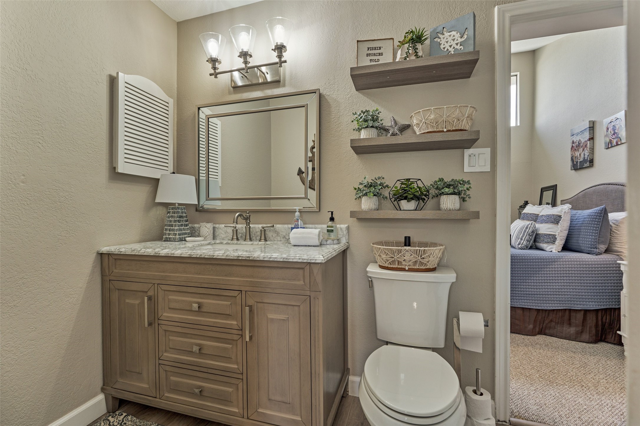 5 April Point Drive South Montgomery, TX 77356 - Photo 18 of 26 a bathroom with a granite countertop toilet a sink and a mirror
