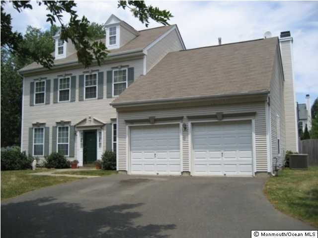 700 Adelphia Road Freehold, NJ 07728 - Photo 1 of 3 a front view of a house with a yard and garage