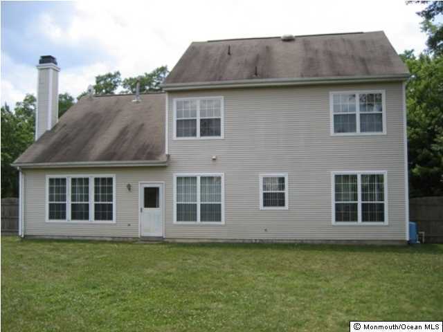 700 Adelphia Road Freehold, NJ 07728 - Photo 3 of 3 a front view of a house with a garden