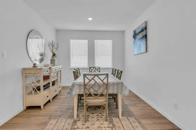 a dining room with furniture and wooden floor