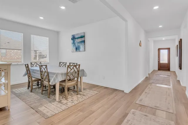 a dining room with furniture and wooden floor