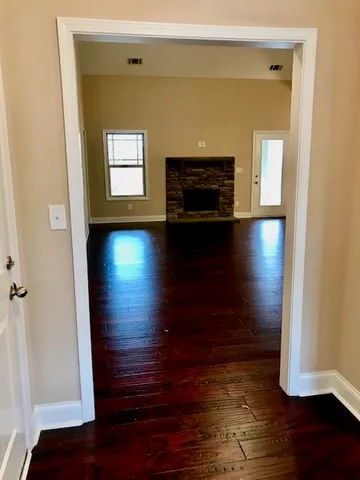 a view of a room with wooden floor and cabinet