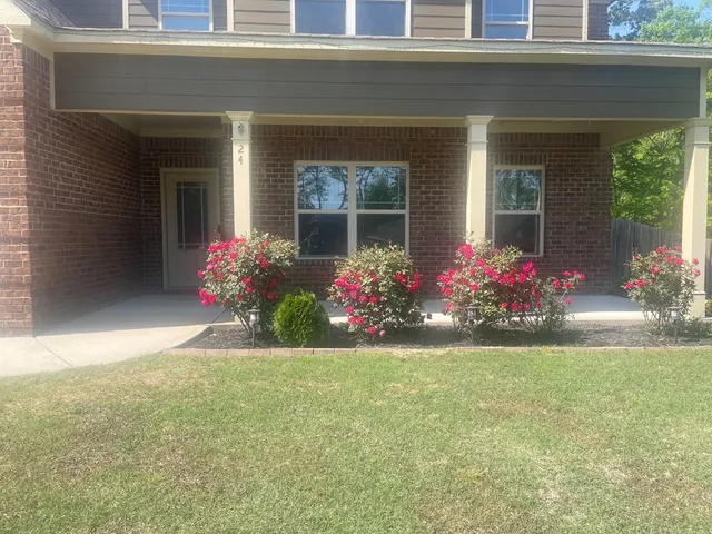 a front view of a house with a garden