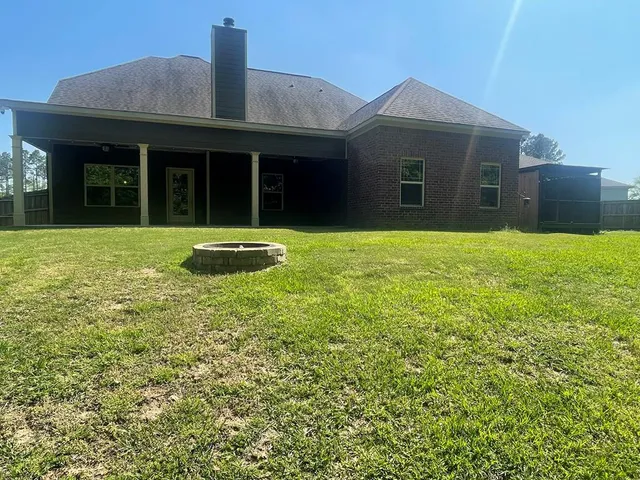 a view of a kitchen with wooden floor and a ceiling fan