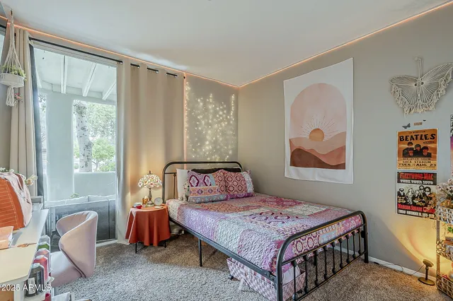 a bedroom with a bed and a window