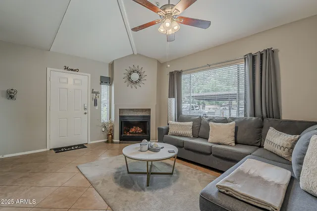 a living room with furniture and a fireplace