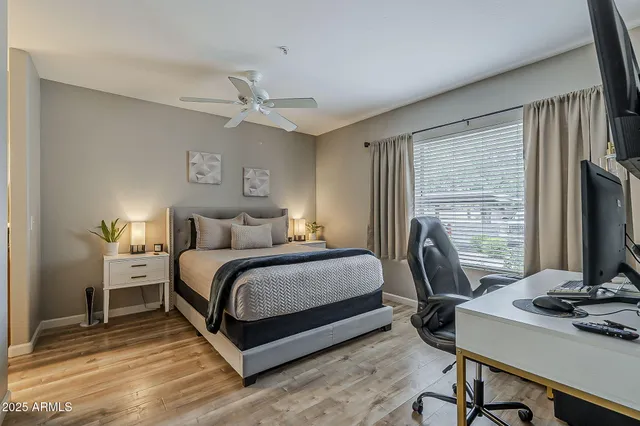 a bedroom with a bed and a desk