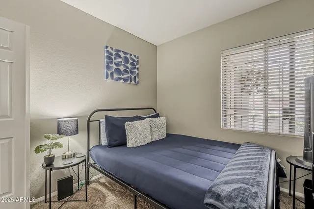 a bedroom with a bed and window