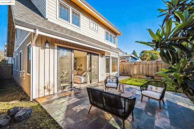 a view of a house with backyard and sitting area