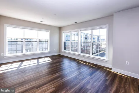 a large kitchen with a table and chairs