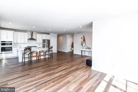a large kitchen with a table and chairs in it