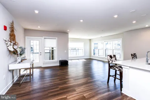 a kitchen with stainless steel appliances a refrigerator sink and cabinets