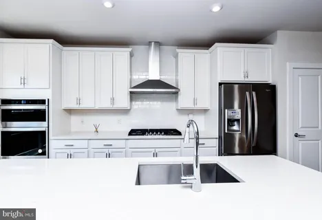 a view of a bathroom with sink and wooden floor