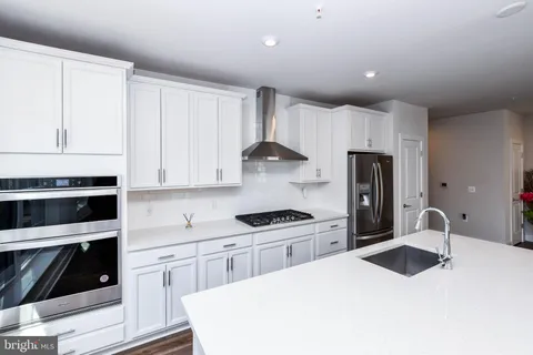 a view of a hallway with wooden floor and closet