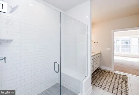 an empty room with wooden floor and a hallway