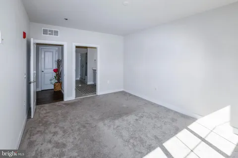 a view of ocean with boats and trees in the background