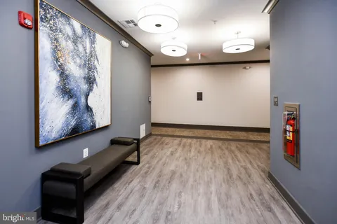 an empty room with wooden floor and door