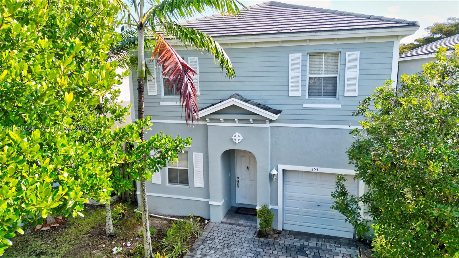 a front view of a house with a garden