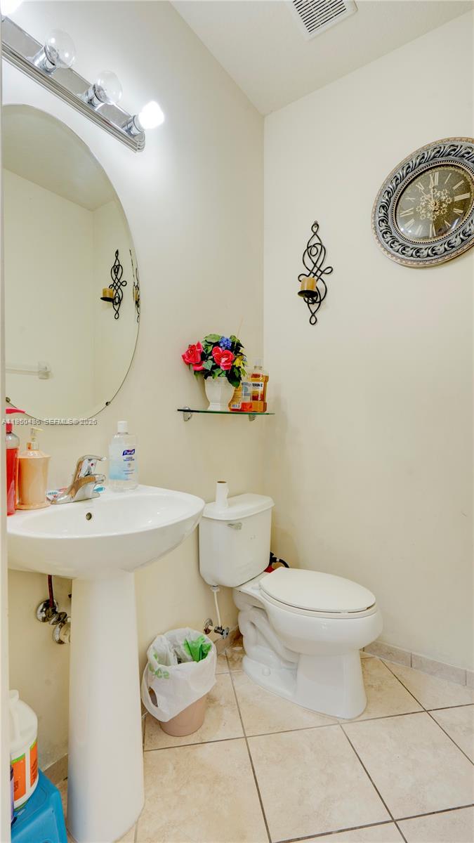 355 Northeast 31st Avenue Homestead, FL 33033 - Photo 22 of 62 a bathroom with a sink mirror vanity and toilet