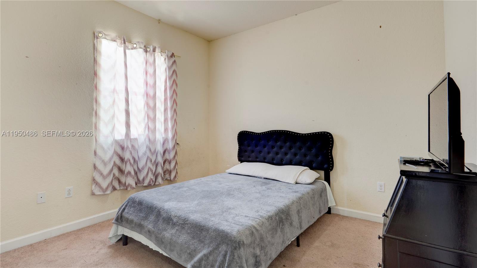 355 Northeast 31st Avenue Homestead, FL 33033 - Photo 27 of 62 a bedroom with a bed and flat screen tv