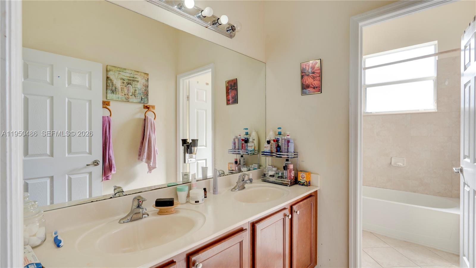 355 Northeast 31st Avenue Homestead, FL 33033 - Photo 30 of 62 a bathroom with a sink vanity tub and a mirror