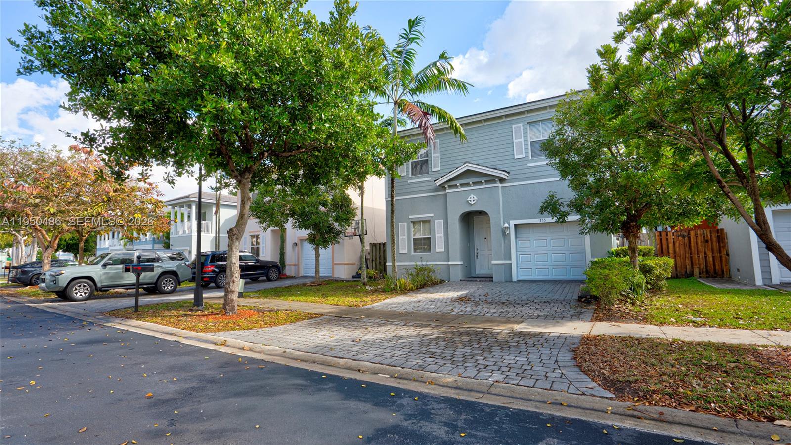 355 Northeast 31st Avenue Homestead, FL 33033 - Photo 3 of 62 a view of a white house with a large tree and plants