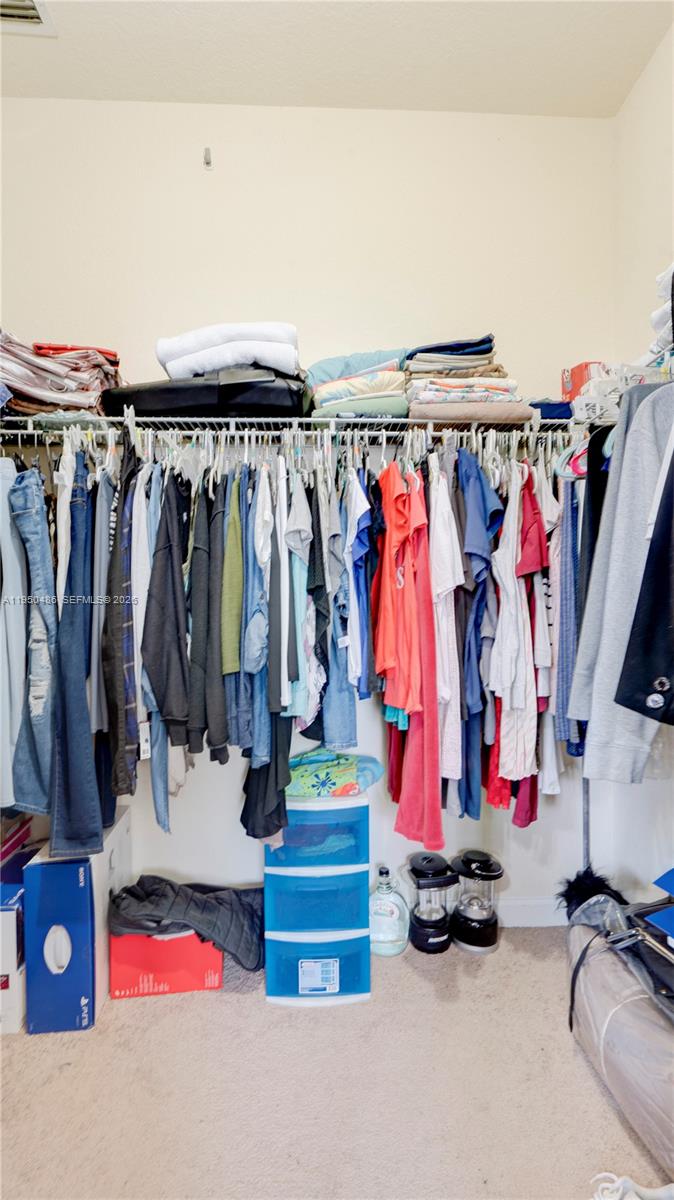 355 Northeast 31st Avenue Homestead, FL 33033 - Photo 42 of 62 a view of walk in closet with clothes
