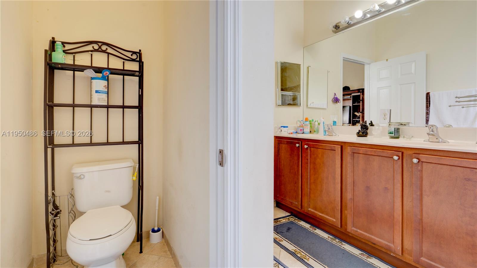355 Northeast 31st Avenue Homestead, FL 33033 - Photo 45 of 62 a bathroom with a toilet sink and mirror