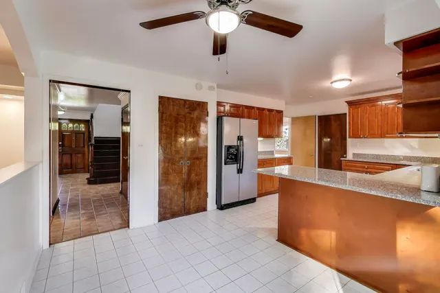 a view of a kitchen with a sink and a refrigerator