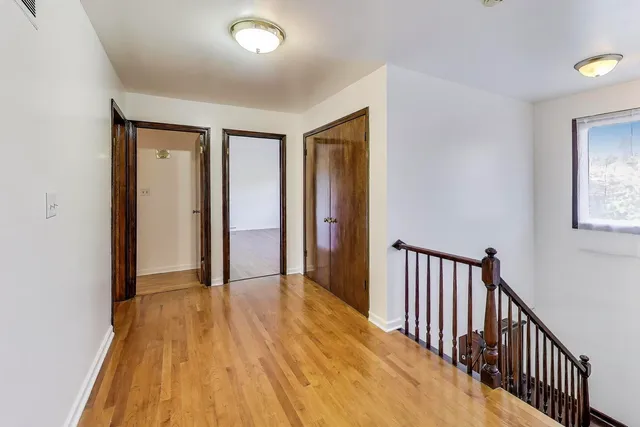 a view of hallway with wooden floor