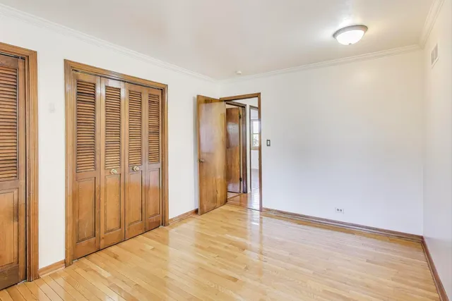 an empty room with wooden floor and a window