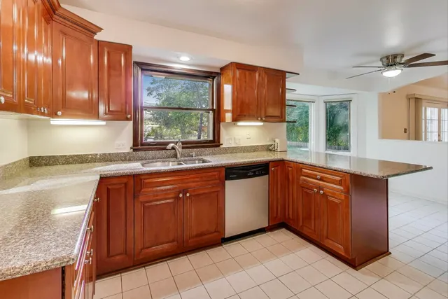 a kitchen with stainless steel appliances granite countertop a sink and cabinets