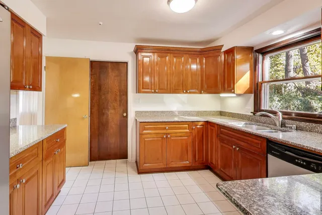 a kitchen with stainless steel appliances granite countertop a refrigerator and sink