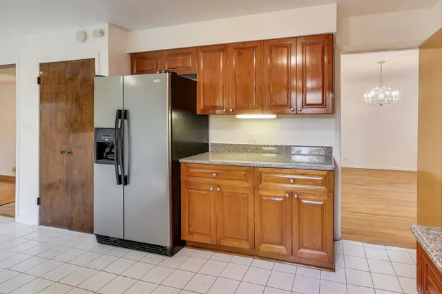 a kitchen with stainless steel appliances granite countertop a refrigerator and a stove