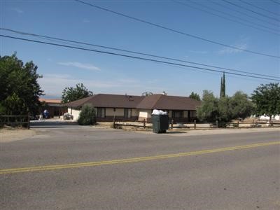 19367 Seneca Road Apple Valley, CA 92307 - Photo 1 of 1 a view of a building and car parked on the road