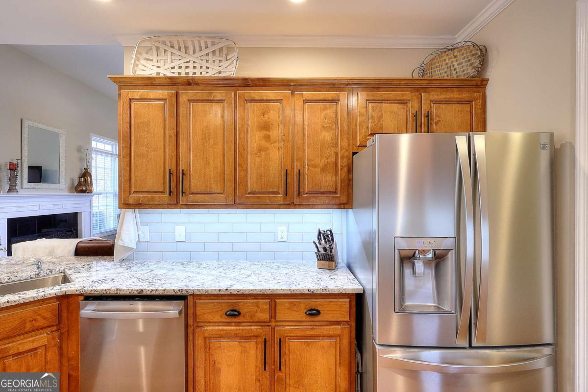 2385 Amberbrook Lane Grayson, GA 30017 - Photo 11 of 57 a kitchen with granite countertop stainless steel appliances a refrigerator and a sink