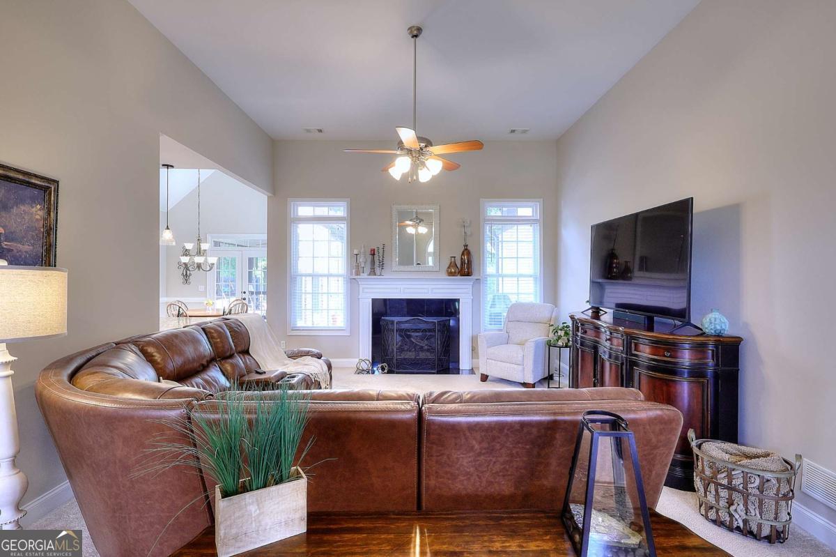 2385 Amberbrook Lane Grayson, GA 30017 - Photo 17 of 57 a living room with furniture a fireplace and a flat screen tv