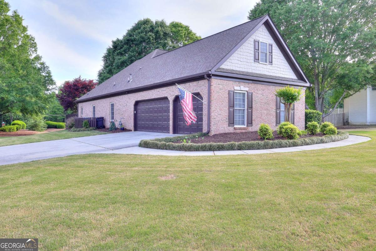 2385 Amberbrook Lane Grayson, GA 30017 - Photo 2 of 57 a front view of house with yard and trees around