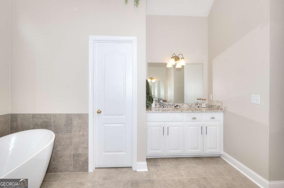2385 Amberbrook Lane Grayson, GA 30017 - Photo 25 of 57 a bathroom with a sink and a mirror