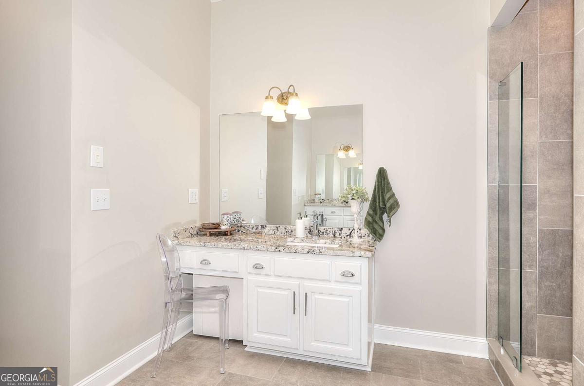 2385 Amberbrook Lane Grayson, GA 30017 - Photo 26 of 57 a bathroom with a sink and a mirror