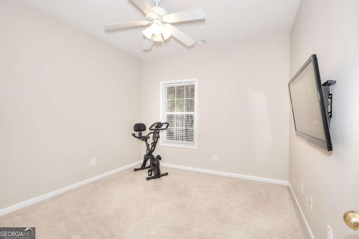 2385 Amberbrook Lane Grayson, GA 30017 - Photo 30 of 57 a view of a livingroom with a chandelier fan and a window
