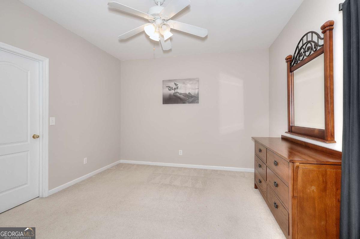 2385 Amberbrook Lane Grayson, GA 30017 - Photo 31 of 57 an empty room with windows and fan