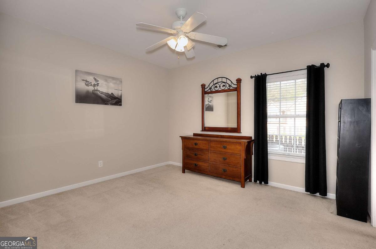 2385 Amberbrook Lane Grayson, GA 30017 - Photo 32 of 57 a room with closet and a ceiling fan