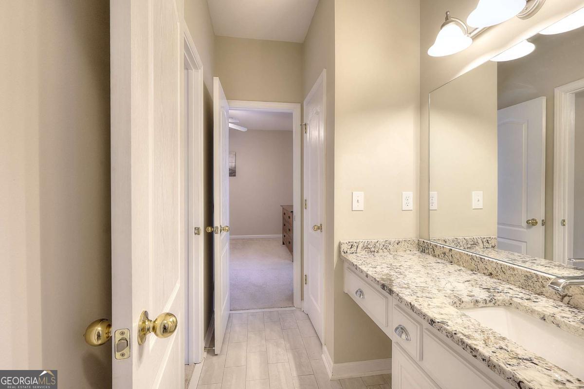 2385 Amberbrook Lane Grayson, GA 30017 - Photo 36 of 57 a bathroom with a granite countertop sink and a mirror