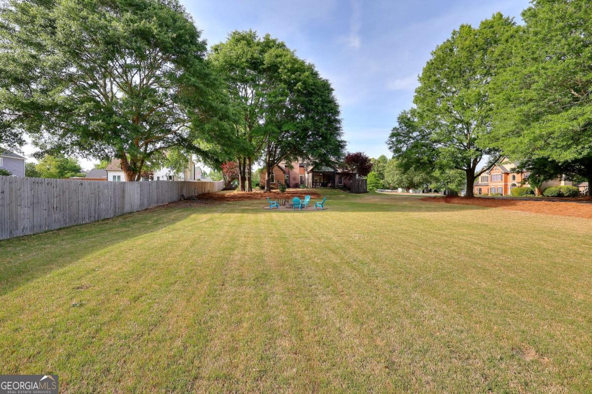 2385 Amberbrook Lane Grayson, GA 30017 - Photo 44 of 57 a view of a swimming pool and trees in the background