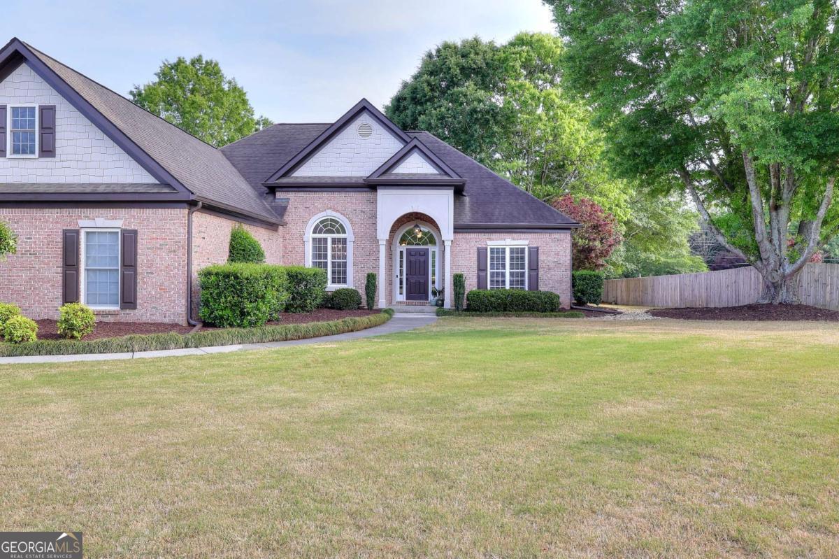 2385 Amberbrook Lane Grayson, GA 30017 - Photo 47 of 57 a front view of a house with a yard and garage