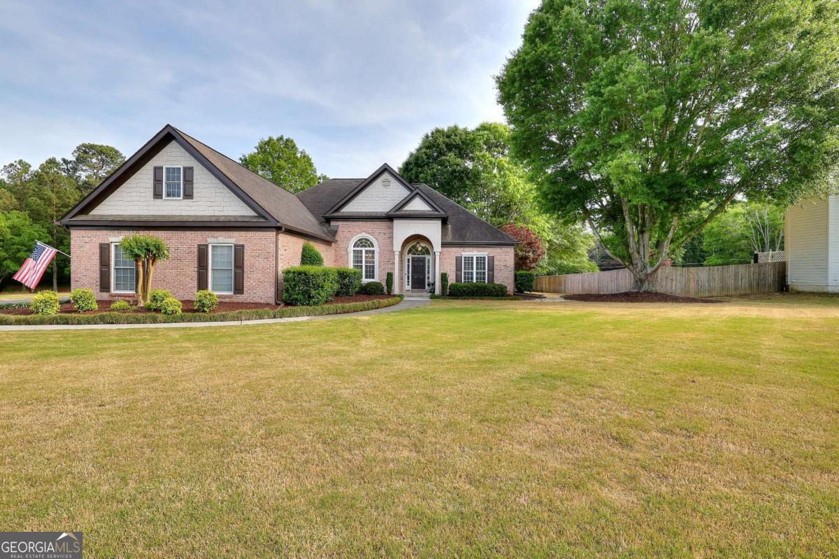 2385 Amberbrook Lane Grayson, GA 30017 - Photo 48 of 57 a front view of house with yard and green space