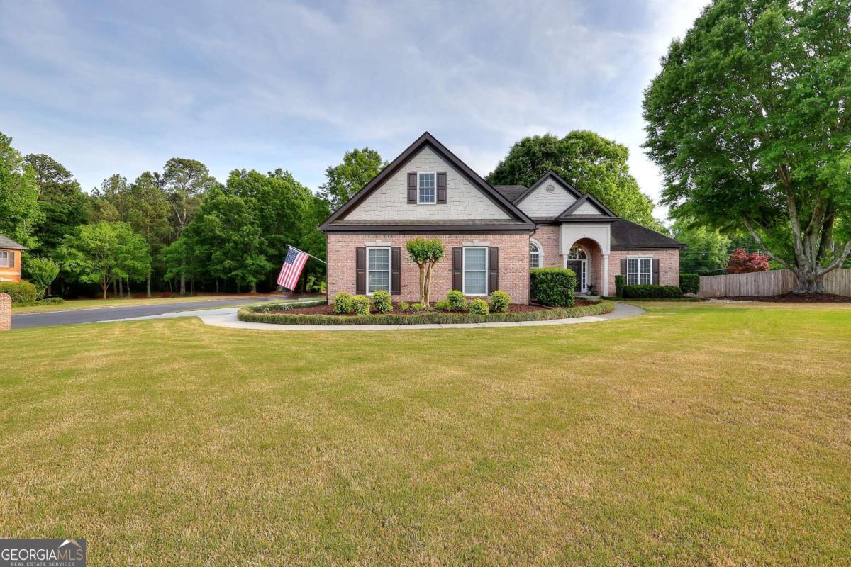 2385 Amberbrook Lane Grayson, GA 30017 - Photo 49 of 57 a front view of house with yard and green space